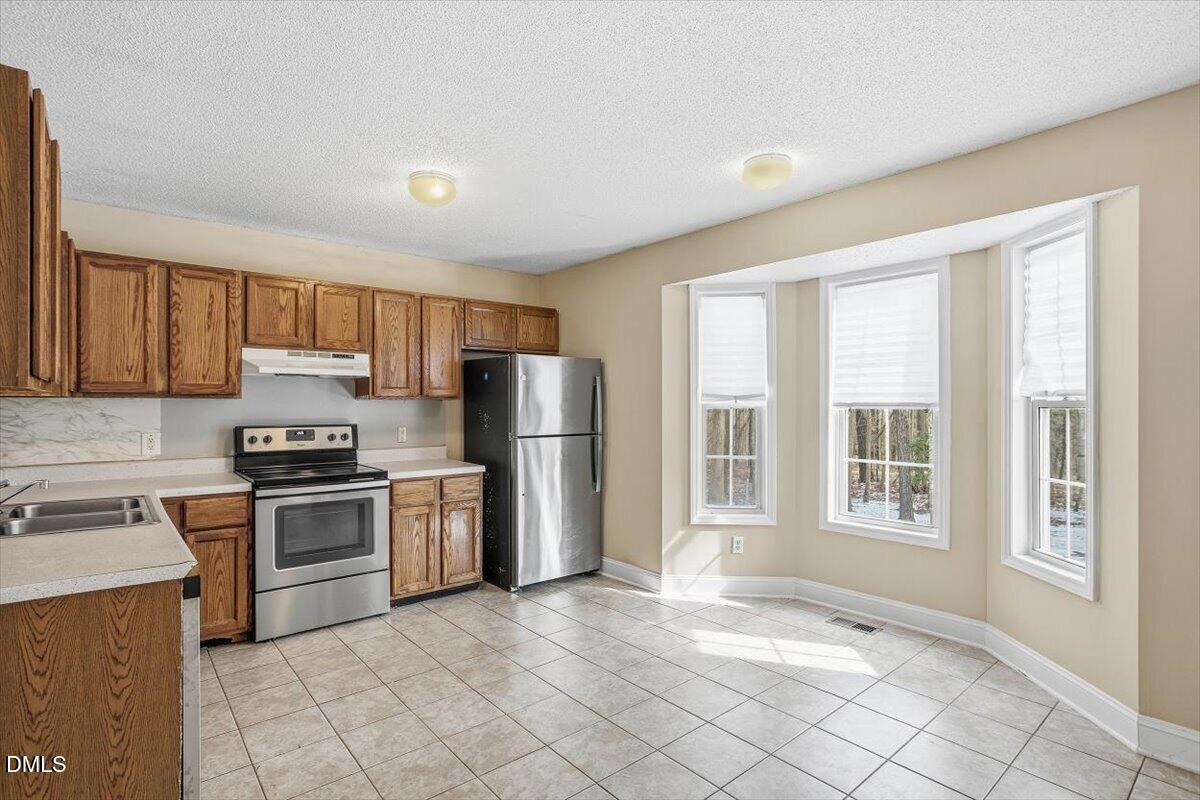 1013 Spawn Place Knightdale, NC 27545 - Photo 11 of 22 a kitchen with stainless steel appliances granite countertop a stove a sink dishwasher a refrigerator and cabinets with wooden floor