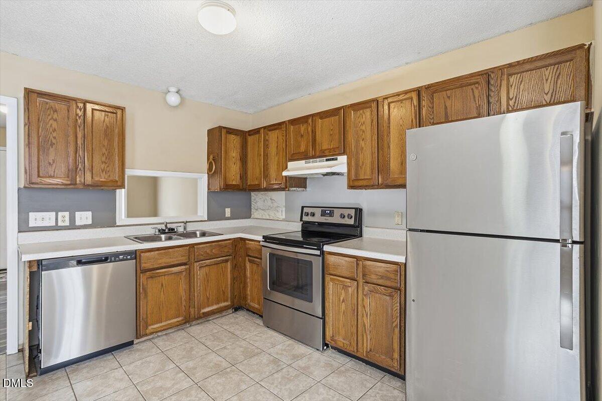 1013 Spawn Place Knightdale, NC 27545 - Photo 12 of 22 a white refrigerator freezer sitting inside of a kitchen