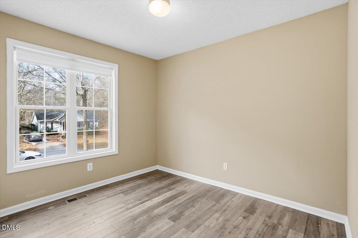 1013 Spawn Place Knightdale, NC 27545 - Photo 18 of 22 a view of empty room with wooden floor and fan