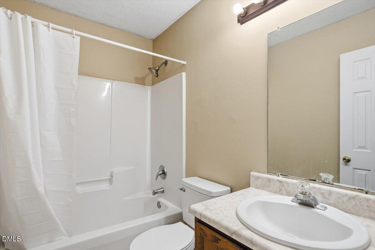 1013 Spawn Place Knightdale, NC 27545 - Photo 20 of 22 a bathroom with a sink toilet and shower