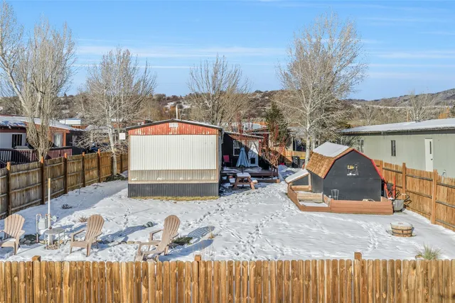 a view of a house with wooden fence