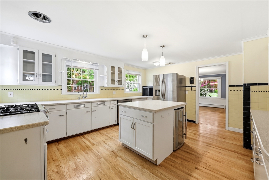 130 Connecticut Avenue Springfield, MA 01107 - Photo 17 of 40 a kitchen with a stove a sink a refrigerator and wooden floor