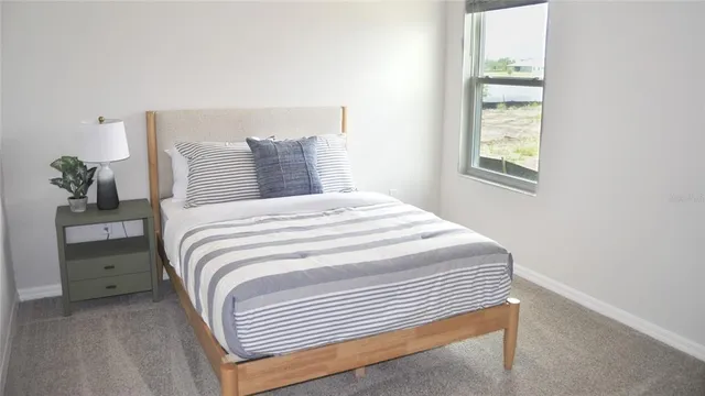 a bedroom with a bed and a window