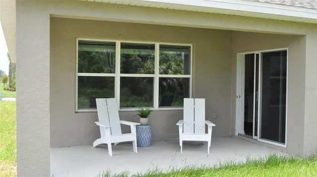 a view of two chairs in the porch