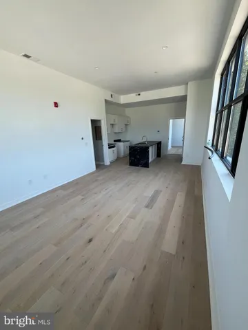 an empty room with furniture and fireplace