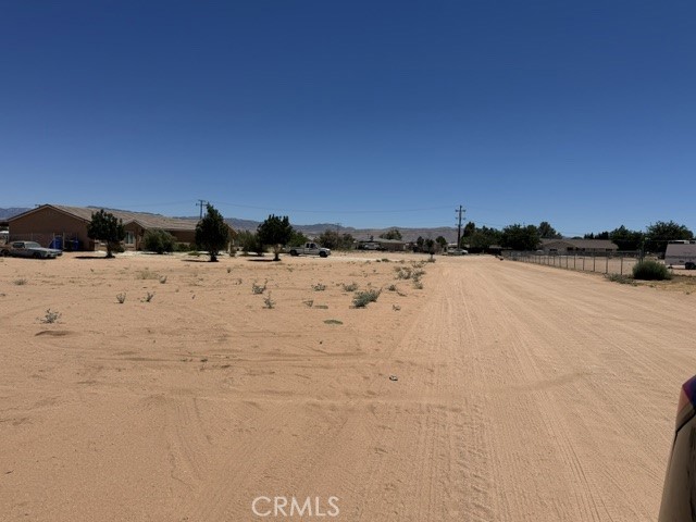 21832 Thunderbird Road Apple Valley, CA 92307 - Photo 6 of 6 View from the left side of the house to the main entrance road of the house.