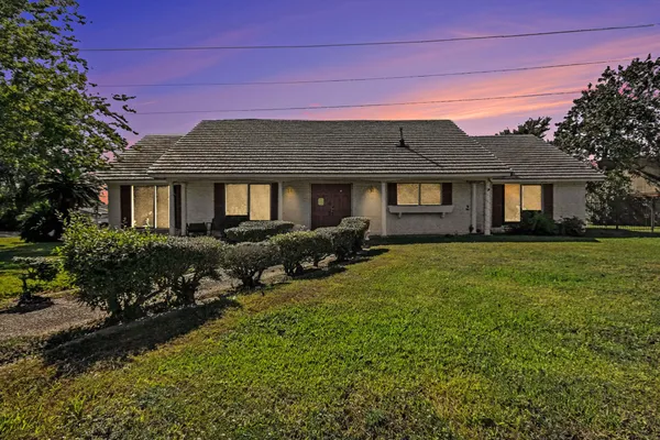 a front view of a house with a garden