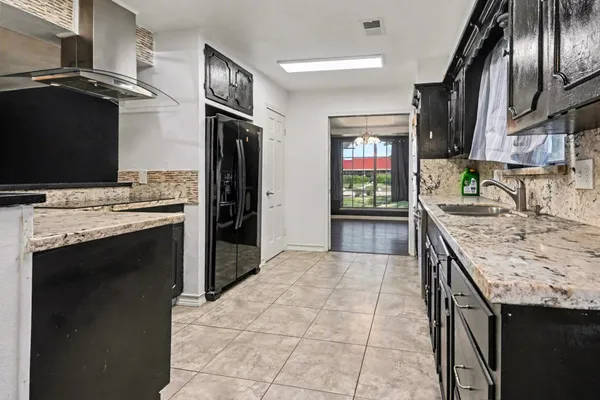 a kitchen with stainless steel appliances granite countertop a stove and a refrigerator