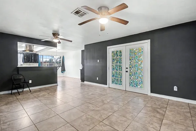 a view of a livingroom with a ceiling fan and window