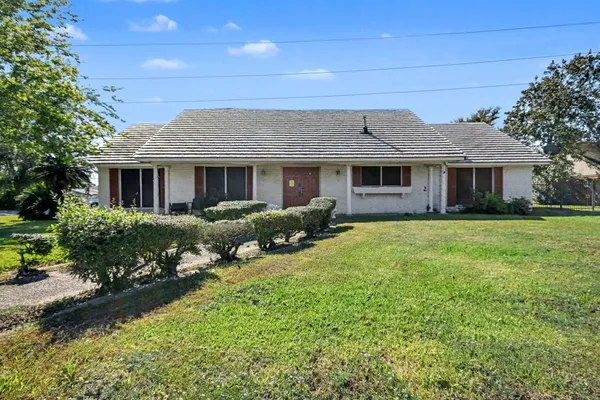 a front view of house with yard and green space