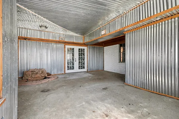 a view of a park with plants and a palm tree
