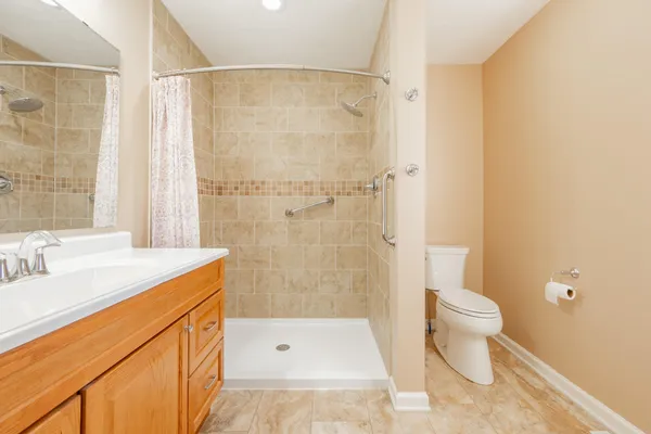 a bathroom with a sink a toilet and shower