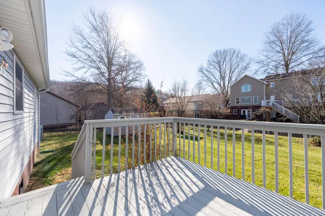 a view of a swimming pool with a patio and couches chairs