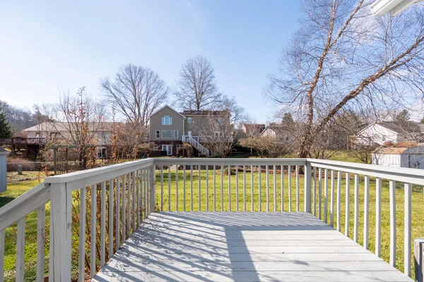 a view of a balcony with wooden fence and floor