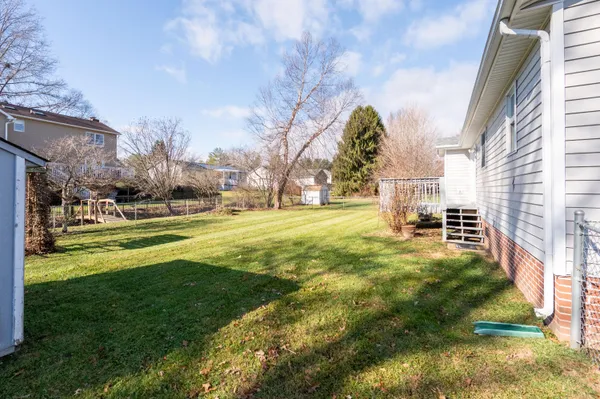 a view of a park with swings and a yard
