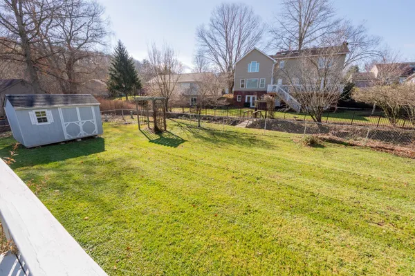 a swimming pool with outdoor seating and yard