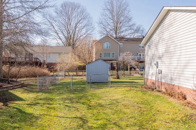 a swimming pool with outdoor seating and yard