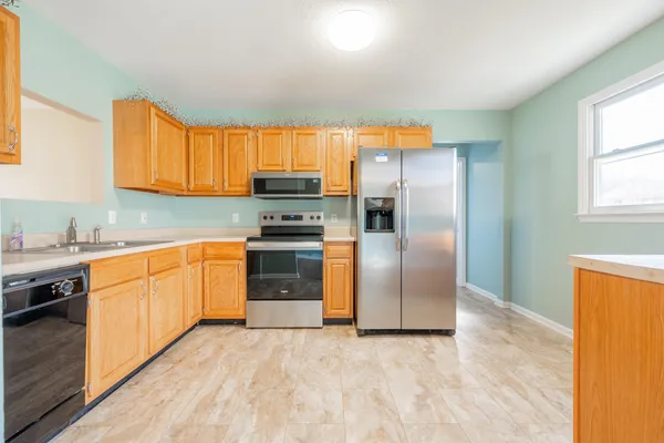 a kitchen with granite countertop a refrigerator and a sink
