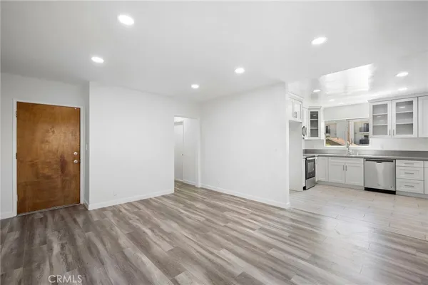 a view of a kitchen with center island and stainless steel appliances