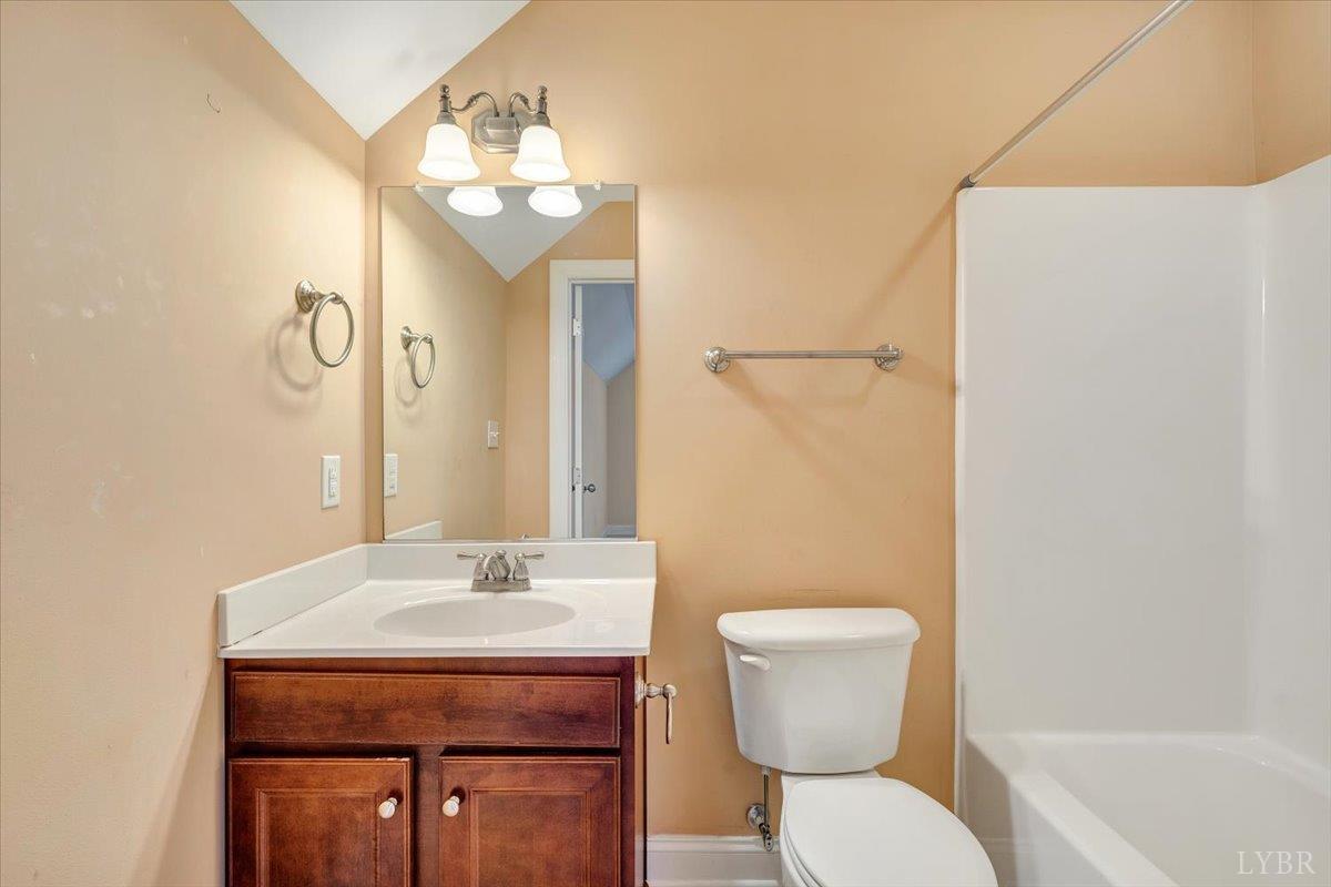 1250 Our Cove Road Huddleston, VA 24104 - Photo 37 of 70 a bathroom with a toilet a sink and mirror
