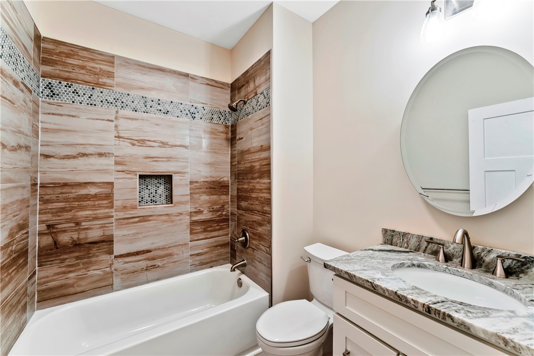 110 Gabriel Way Pickens, SC 29671 - Photo 30 of 48 A well-appointed bathroom with natural-toned tile work and a sleek granite vanity.