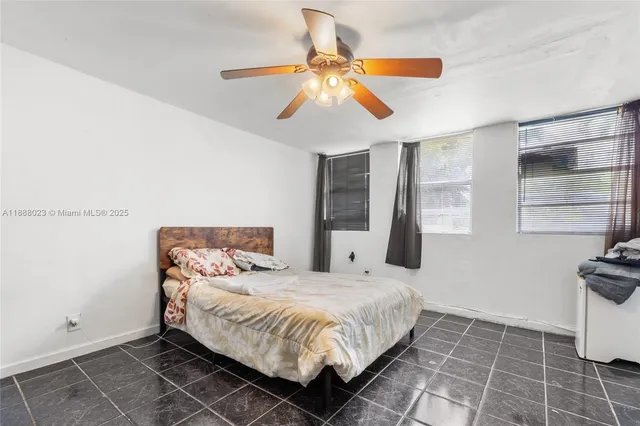 a bedroom with a bed and a ceiling fan