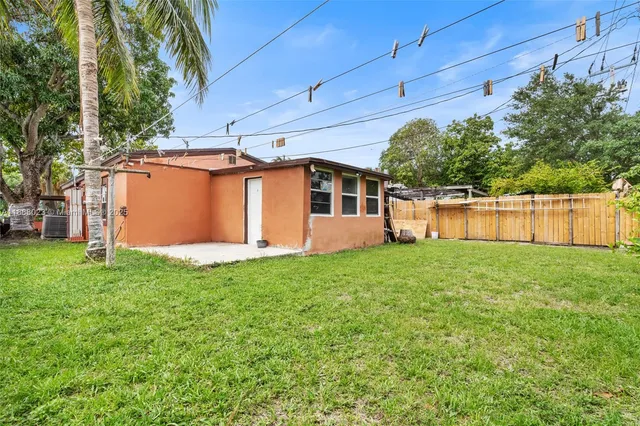 a view of a backyard with plants and a garden