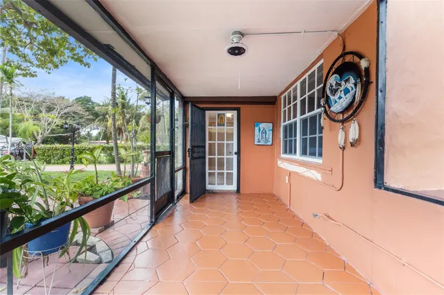 a view of a porch with furniture and a window