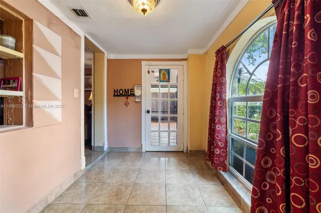 a view of an entryway with furniture and front door