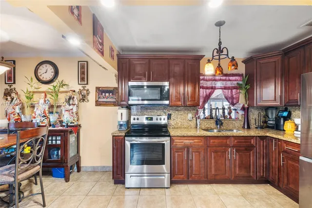 a kitchen with stainless steel appliances granite countertop a stove and cabinets