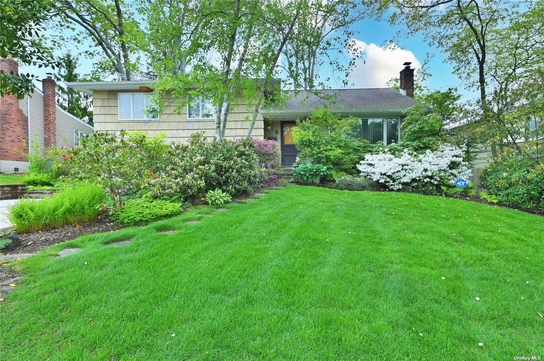 9 Simpson Drive Old Bethpage, NY 11804 - Photo 1 of 1 a view of a garden with a house