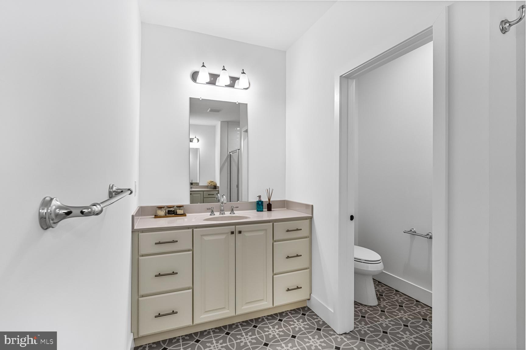10206 Donatello Drive Princeton, NJ 08540 - Photo 24 of 30 a bathroom with a toilet sink and mirror
