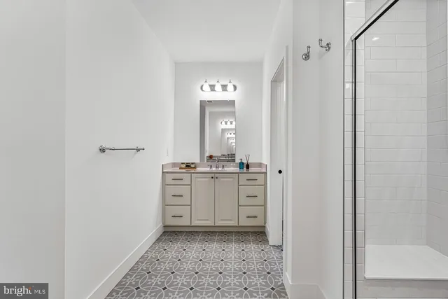 a bathroom with a granite countertop sink a mirror and a vanity