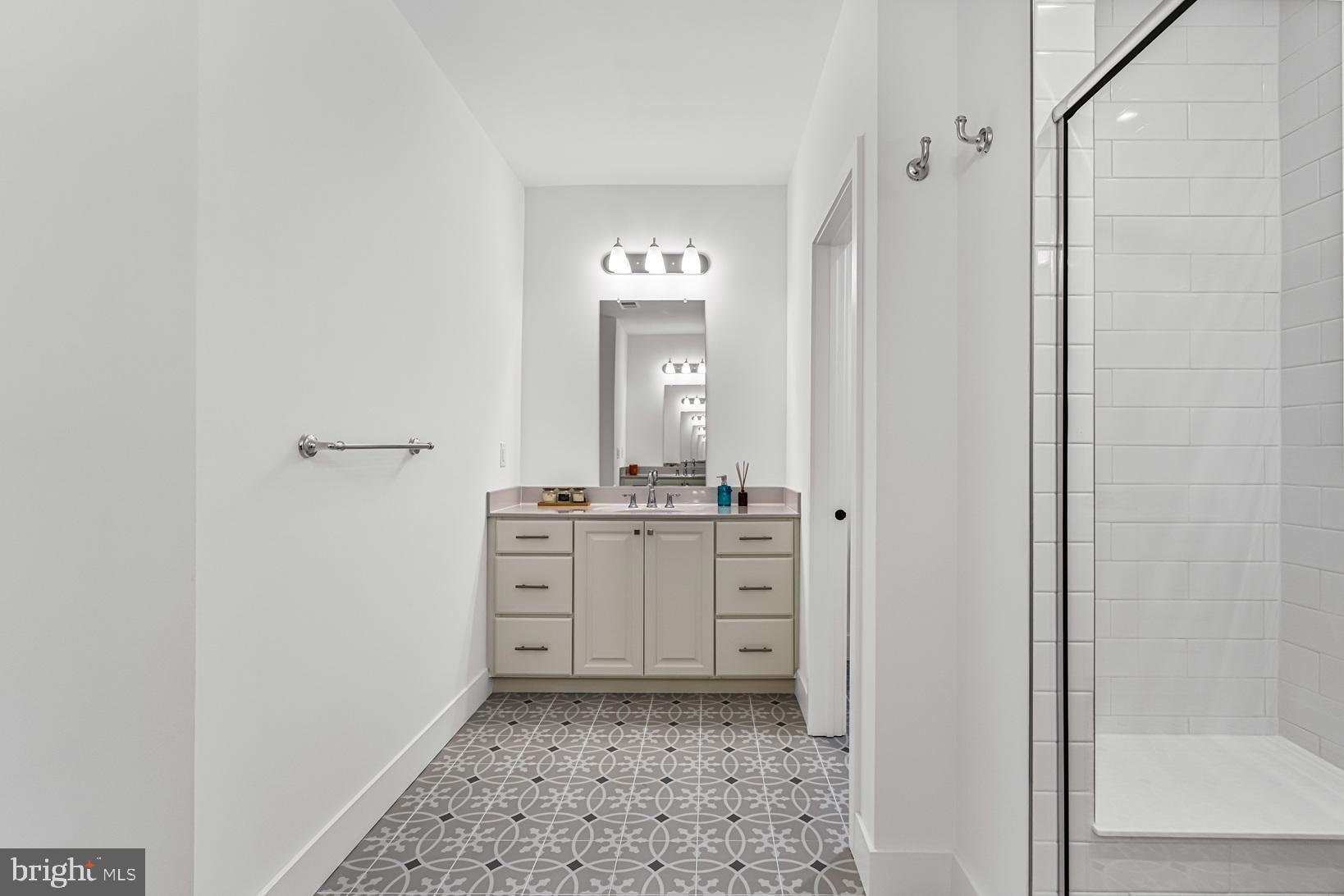 10206 Donatello Drive Princeton, NJ 08540 - Photo 25 of 30 a bathroom with a granite countertop sink a mirror and a vanity