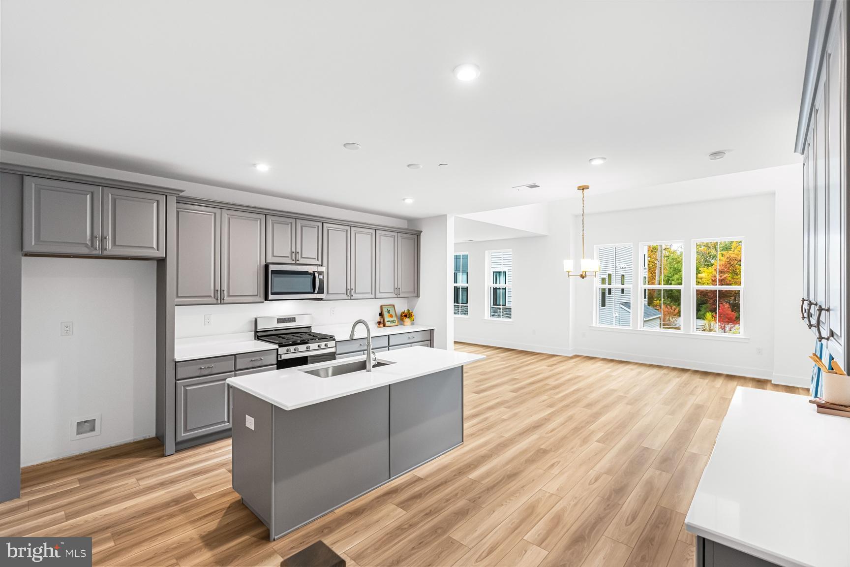 10206 Donatello Drive Princeton, NJ 08540 - Photo 6 of 30 a kitchen with stainless steel appliances granite countertop a stove top oven a sink dishwasher and a refrigerator with wooden floor