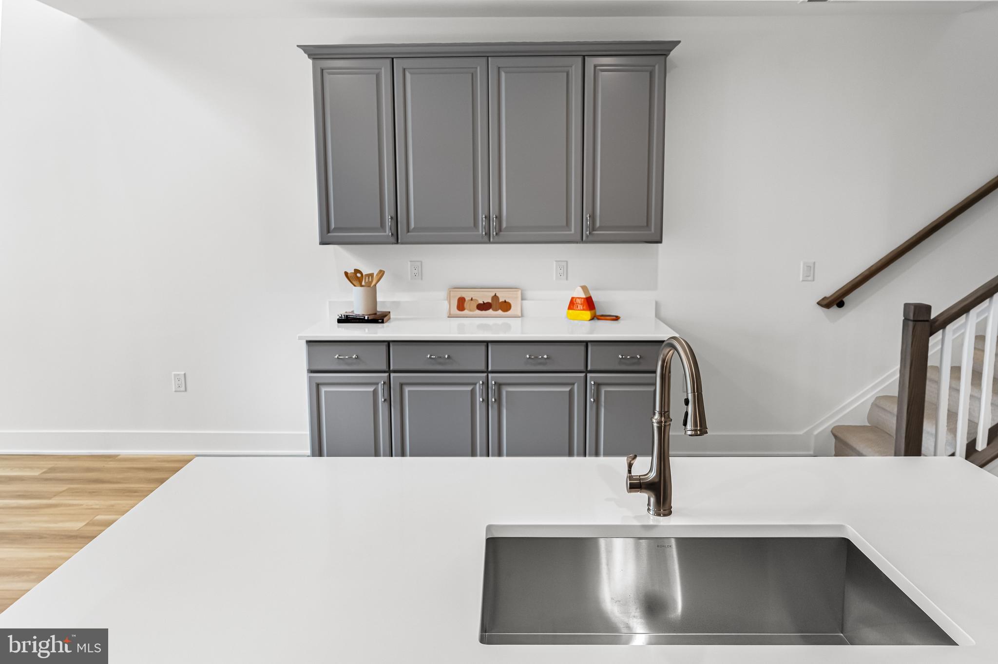 10206 Donatello Drive Princeton, NJ 08540 - Photo 8 of 30 a kitchen with stainless steel appliances a sink dishwasher a stove with wooden floor