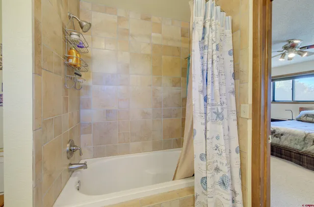 a bathroom with a bathtub and shower