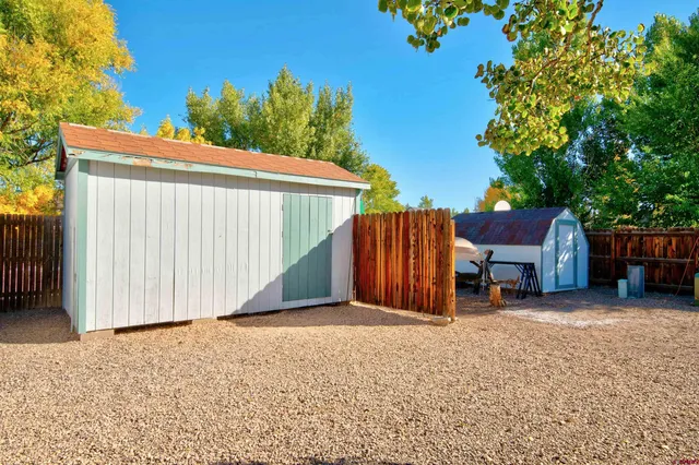 a view of a house with a backyard and garage