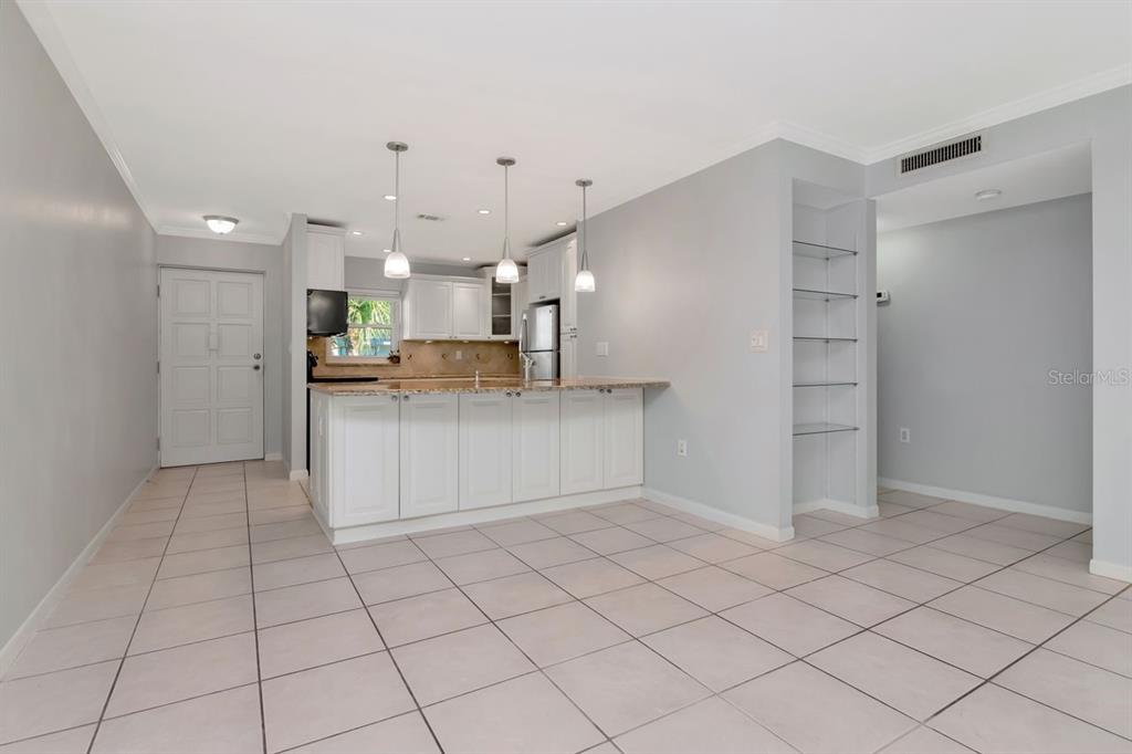 2650 Countryside Boulevard, Unit F303 Clearwater, FL 33761 - Photo 23 of 39 a kitchen with kitchen island granite countertop appliances cabinets and a sink