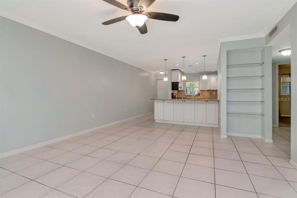 2650 Countryside Boulevard, Unit F303 Clearwater, FL 33761 - Photo 24 of 39 a view of a kitchen with cabinet and a chandelier fan