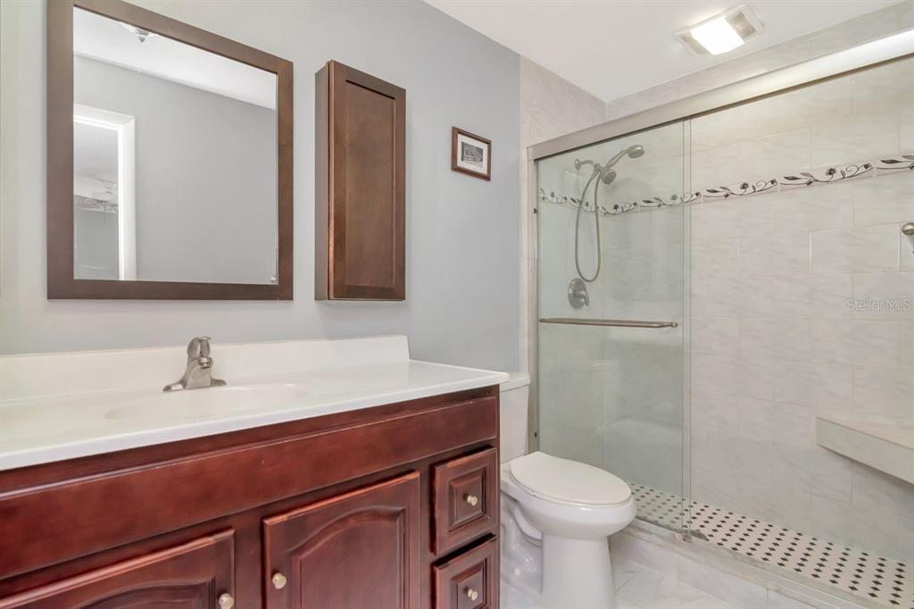 2650 Countryside Boulevard, Unit F303 Clearwater, FL 33761 - Photo 32 of 39 a bathroom with a sink toilet and shower