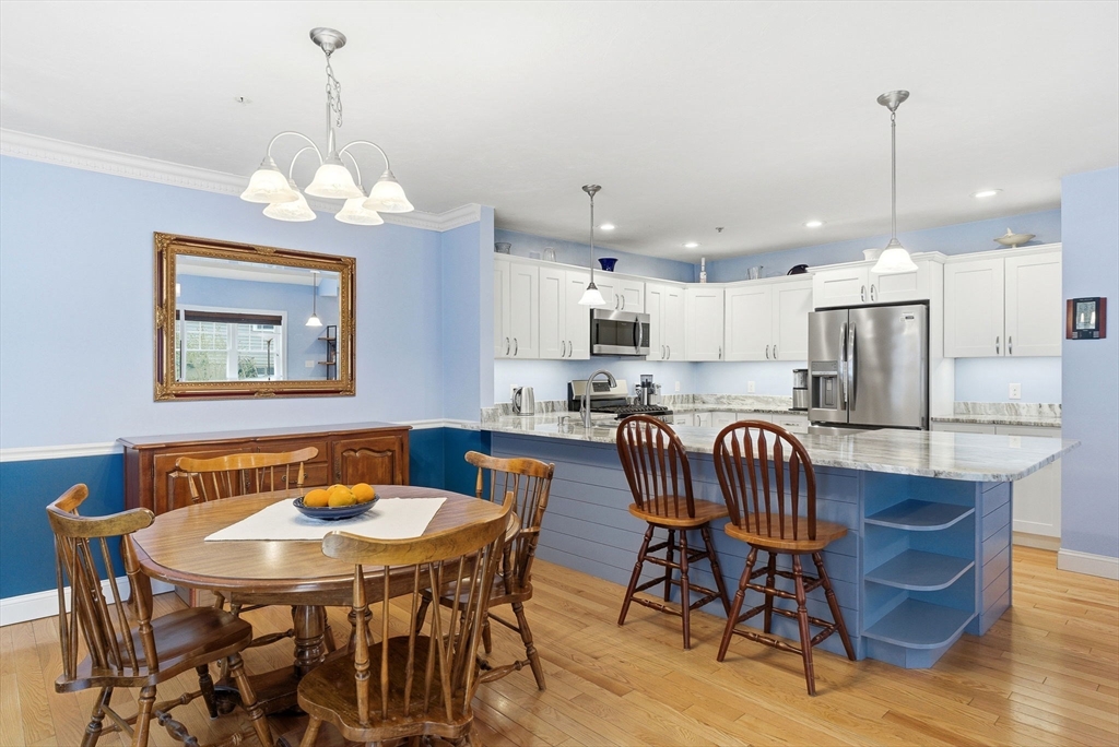 6 Trail Ridge Way, Unit D Harvard, MA 01451 - Photo 15 of 28 a view of a dining room with furniture wooden floor and chandelier