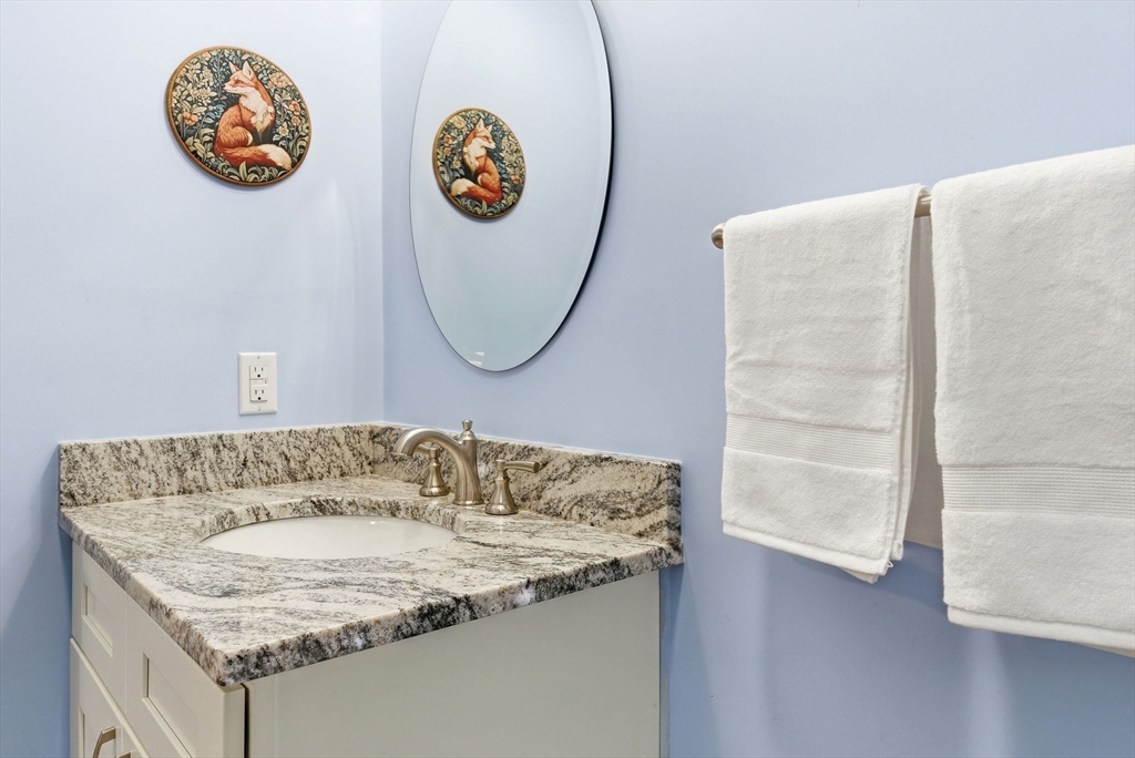 6 Trail Ridge Way, Unit D Harvard, MA 01451 - Photo 16 of 28 a bathroom with a granite countertop sink and a mirror