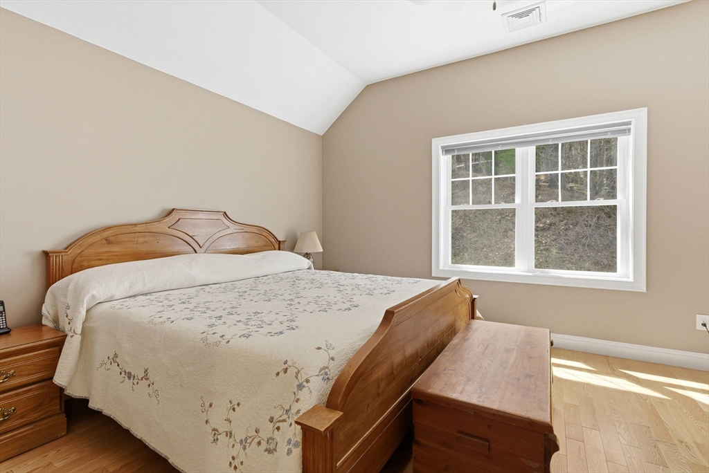 6 Trail Ridge Way, Unit D Harvard, MA 01451 - Photo 23 of 28 a bedroom with a bed and wooden floor