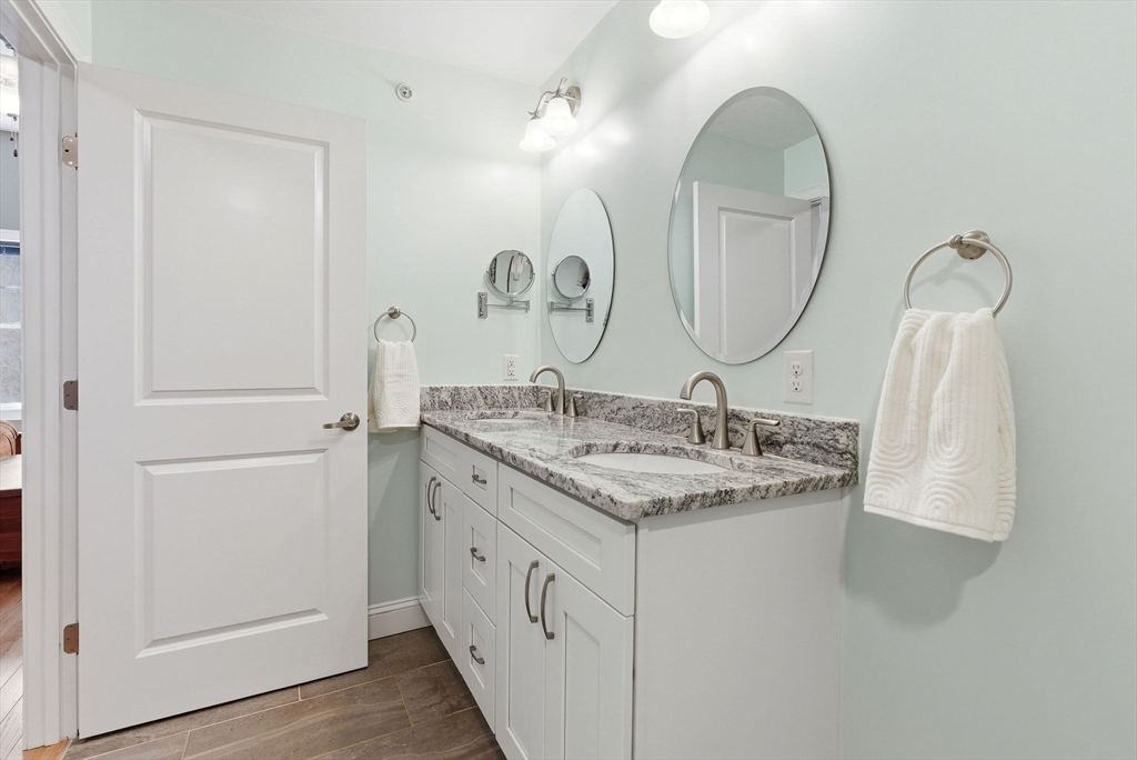 6 Trail Ridge Way, Unit D Harvard, MA 01451 - Photo 25 of 28 a bathroom with a double vanity sink and a mirror