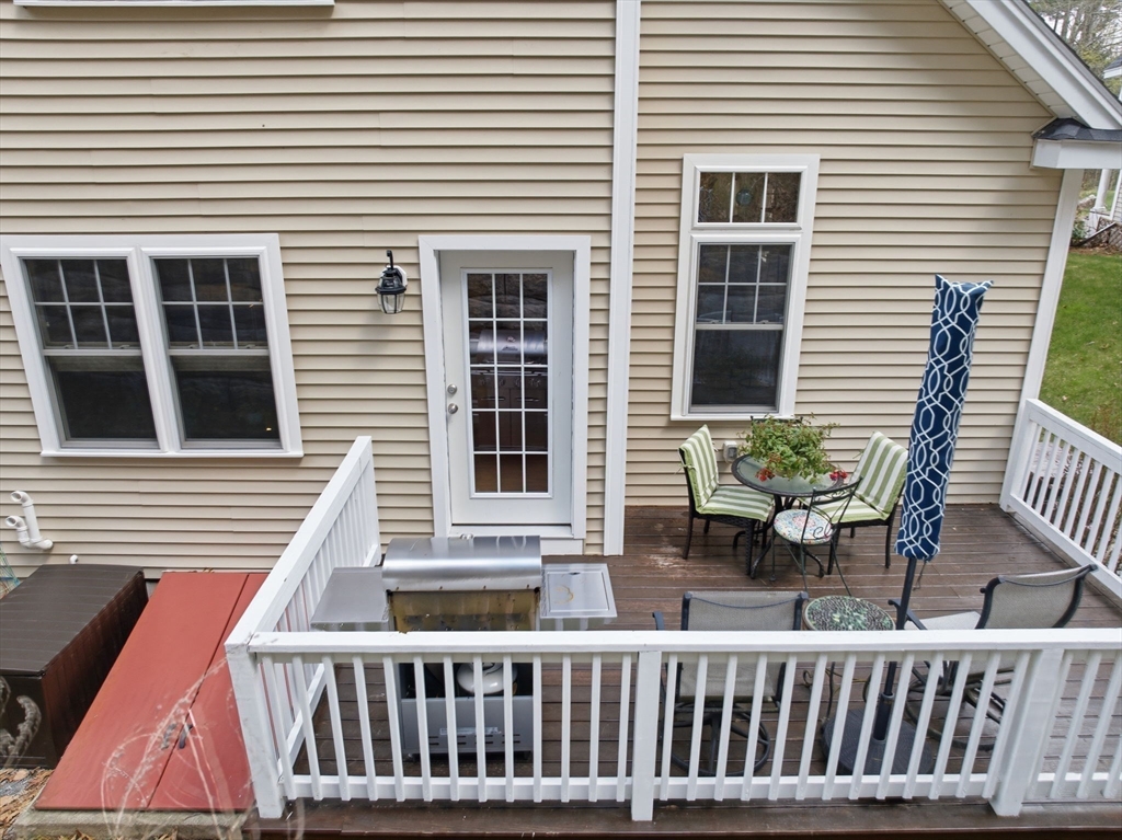 6 Trail Ridge Way, Unit D Harvard, MA 01451 - Photo 7 of 28 a view of a two chairs and table in the back yard