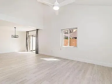 an empty room with windows and cabinet