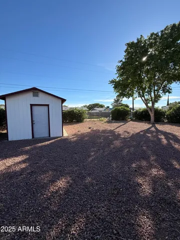a view of a backyard with large trees