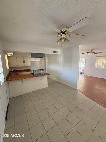 a very nice looking room with a ceiling fan and chandelier