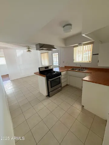 a kitchen with granite countertop a sink and a stove